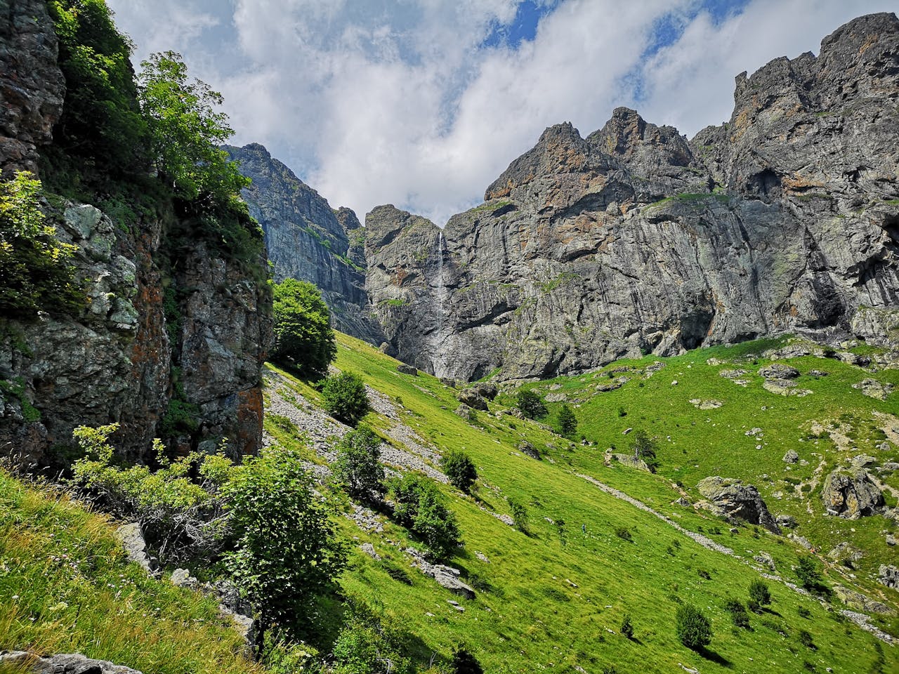 Scenic grassy slopes and towering rock formations in Plovdiv Province, Bulgaria.