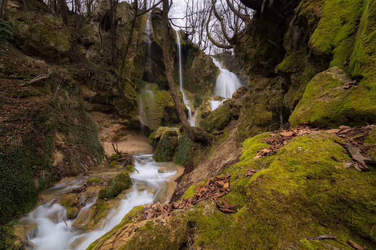 Serene waterfall flowing through moss-covered rocks in Bachkovo Forest, Bulgaria.